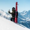 Elisabeth Gerritzen hiking a mountain face with Faction Agent 3X pink skis attached to her bag.