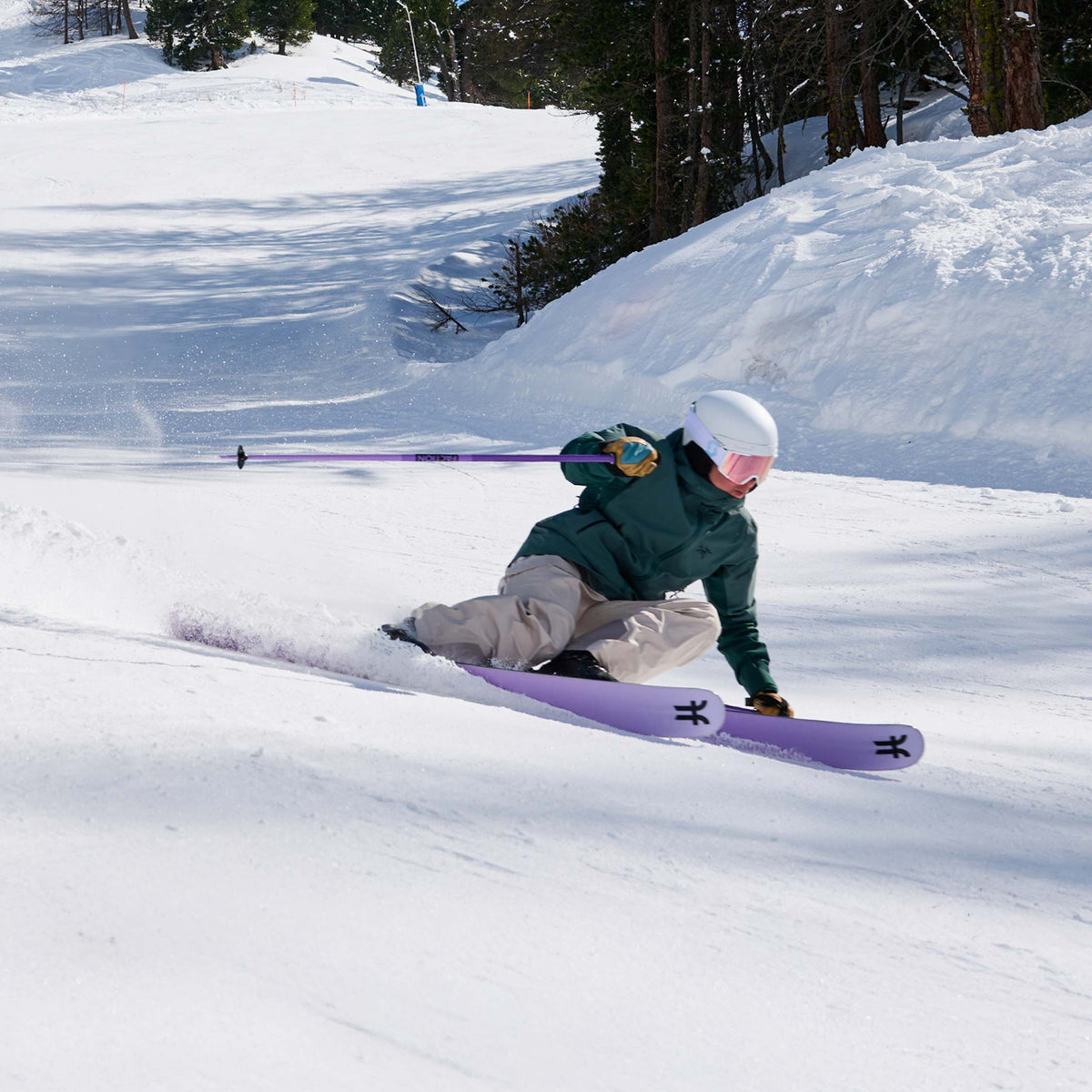 Girl skier carving on purple Dancer 2 all-mountain skis