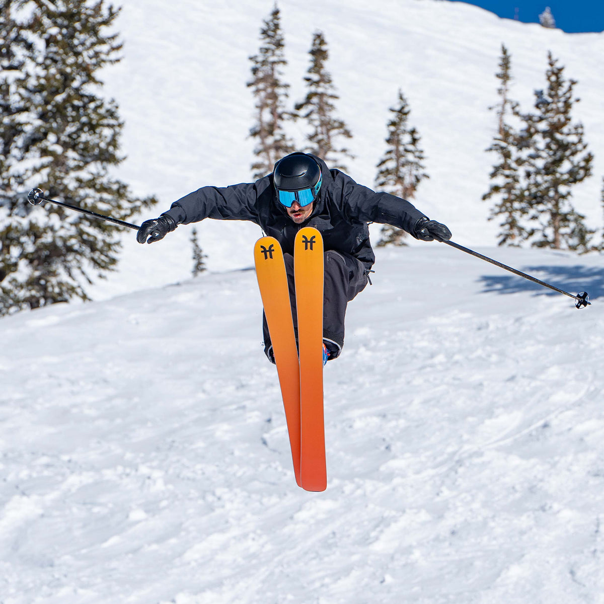 Freeride Skier jumping on orange Dancer 3 Freeride and all-mountain skis